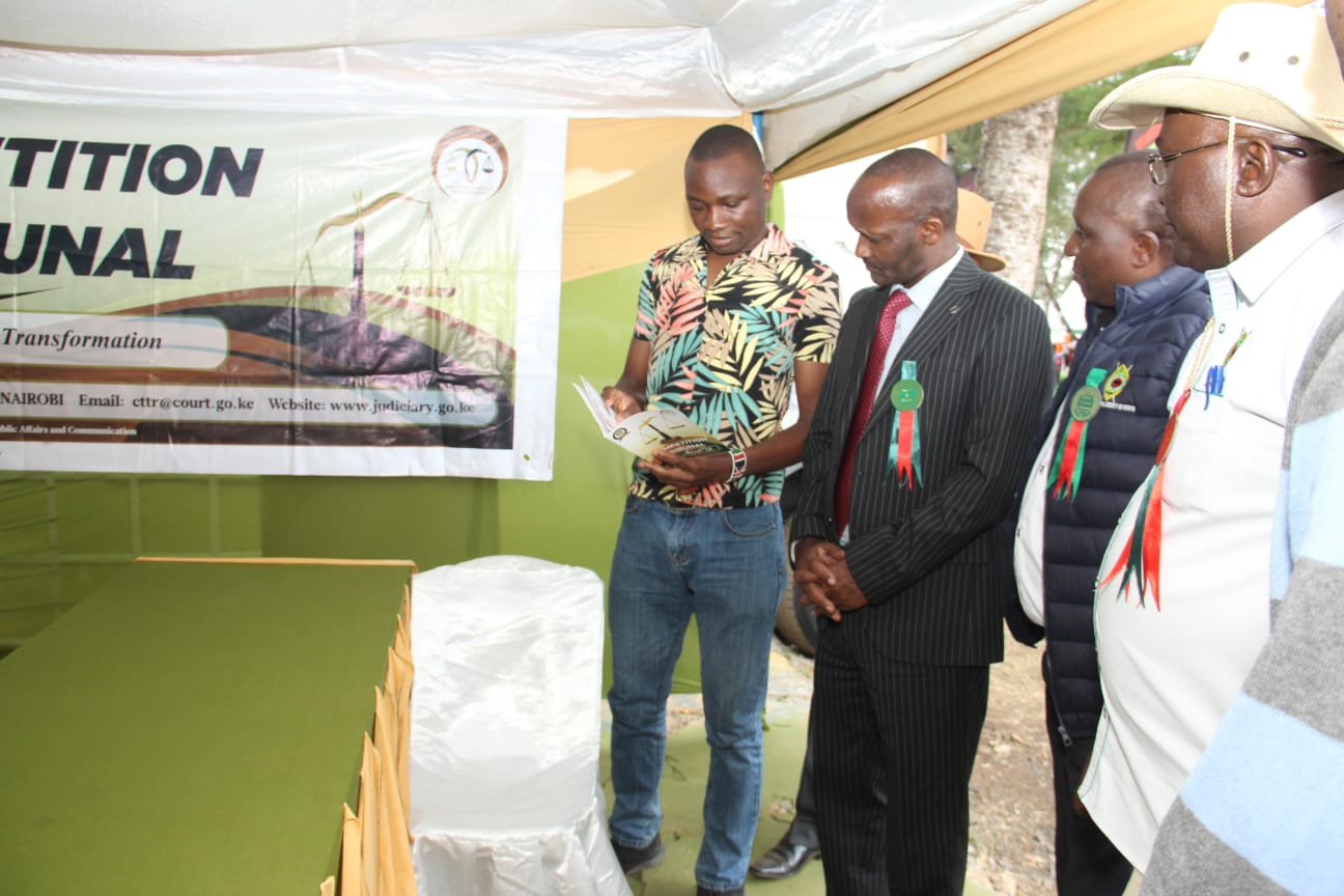 Dr. Wilson Tonui,managing director of the Agricultural Development Corporation visits the Competition Tribunal exhibition stand during the Machakos National Agricultural Show to learn more about the Tribunal's mandate,functions and role in promoting fair competition and access to justice in Kenya