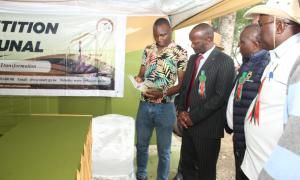 Dr.Wilson Tonui,the Managing Director Kenya Agricultural Development Corporation with other officials being taken through the Tribunal's mandate,role and functions by a representative of the Tribunal during the National Agricultural Show in Machakos