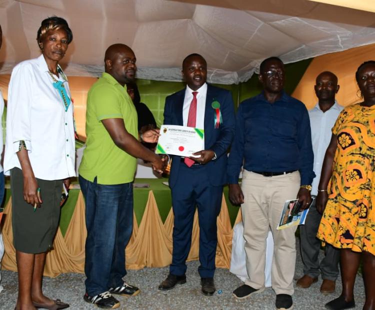 Tribunal secretariat receive a certificate of participation from officials of the County Government of Kakamega during the National Agricultural Show in the county